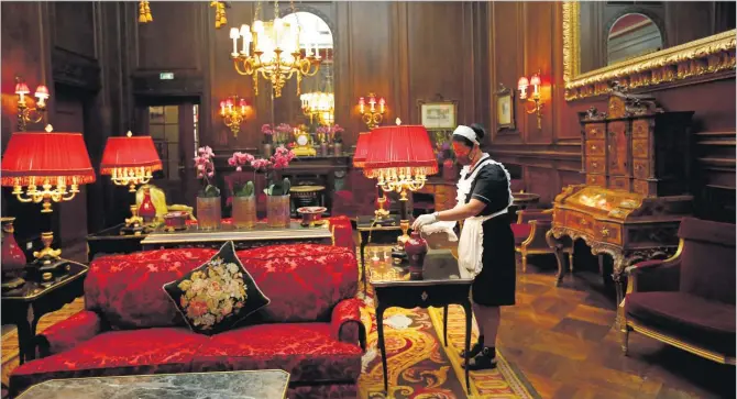  ?? Picture: REUTERS/FILE ?? A cleaning lady wearing a protective face mask wipes dust in the lobby at the Sacher hotel in Vienna, Austria May 28, 2020.