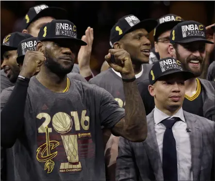  ?? ASSOCIATED PRESS FILE ?? LeBron James celebrates with Coach Tyronn Lue, right, and teammates after the Cavaliers won Game 7over the Warriors to win the 2016 NBA Finals.