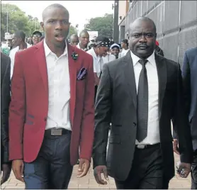  ?? PHOTOS: ANTONIO MUCHAVE ?? Lethebo Rabalago, in maroon jacket, walks with his lawyer Edmond Lubisi after his appearance in the Limpopo High Court in Polokwane yestarday.