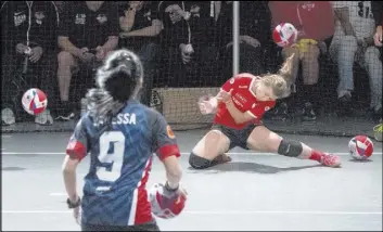  ?? Mary Altaffer The Associated Press ?? An Austria player, right, fails to dodge a ball against Malaysia in women’s competitio­n Saturday in the Dodgeball World Cup in New York.