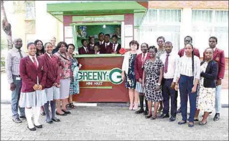  ??  ?? Some students of Greensprin­gs School, Lagos with members of the school management at the GREENY-G Mini Mart stand at the Lekki Campus, which won them $2,000 in the 2018 edition of the School Enterprise Challenge… recently