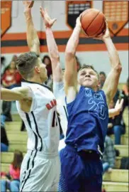  ?? PAUL DICICCO — THE NEWS-HERALD ?? Madison’s Zach Guyer shoots against North during the regular season. Guyer is headed to Wittenberg in the fall.