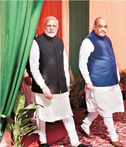  ?? PHOTO: PTI ?? Prime Minister Narendra Modi ( left) with BJP President Amit Shah during the Deepawali Mangal Milan programme at the BJP headquarte­rs in New Delhi on Saturday