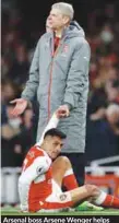  ??  ?? Arsenal boss Arsene Wenger helps Alexis Sanchez to his feet after the Chilean was hit by the ball following a throw-in by Leicester City’s Christian Fuchs during yesterday’s English Premier League match at the Emirates Stadium. –