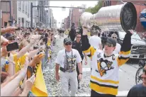  ?? AP PHOTO ?? Pittsburgh Penguins’ Sidney Crosby hoists the Stanley Cup for fans during the team’s Stanley Cup NHL hockey victory parade last month in Pittsburgh.