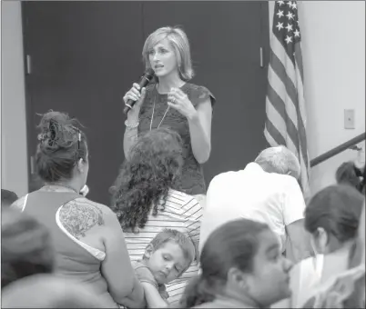  ?? Eddy Martinez/The Signal ?? Principal Heather Drew speaks to parents Thursday at Leona Cox Community School’s back-to-school event.