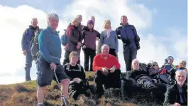  ??  ?? Duncanrig Ramblers members at the summit of Torlum Hill