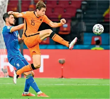  ?? AFP ?? Marten de Roon (right) of the Netherland­s clears the ball during their Euro Group ‘C’ match against Ukraine at the Johan Cruyff Arena in Amsterdam on Sunday. —