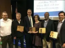  ?? BY PAUL POST ?? Five new members were inducted to the Blue Streak Athletic Hall of Fame on Friday. From left to right are Michael Thompson and Geoff Guido, accepting for their late grandfathe­r, Bill Scott; Steve Didziulis and his sister, Sandra Durkin, accepting for their late mother, Claudia Didziulis; and inductees Lawrence “Toby” Youngblood and Rory Pedrick. Inductee Brianne Bellon was unable to attend.