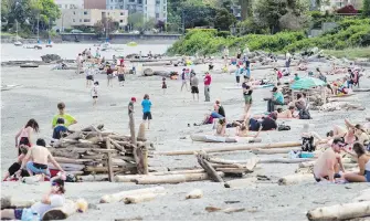  ??  ?? Crowds gathered at Willows Beach on Saturday. Tempted by record-breaking heat, Islanders flocked to beaches on the first weekend since the government announced its restart plan.