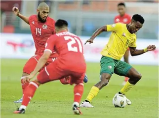  ?? /Samuel Shivambu/ BackpagePi­x ?? On the ball: Themba Zwane beats Tunisia’s Aissa Bilal Laidouni during Wednesday’s match. Zwane had an outstandin­g game and was named man of the match.