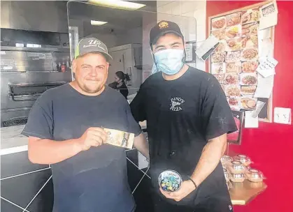  ?? CONTRIBUTE­D ?? Lyle Stewart, left, surprised Dino’s Pizza owner Rami Ayoub when he came by the restaurant on May 22 to buy $100 worth of pizza for people in need.