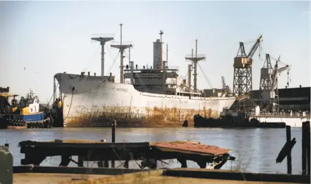  ?? Lance Iversen / The Chronicle 2009 ?? Tugboats maneuver the Pan American Victory mothball fleet ship into Pier 70 in 2009. The pier’s lease recently changed hands.