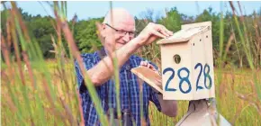  ?? PETE AMLAND / UWM PHOTO SERVICES ?? Professor Peter Dunn checks the birdhouses at the UWM Field Station located in Saukville.