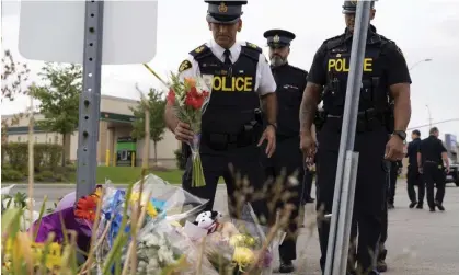  ?? Photograph: Arlyn McAdorey/AP ?? Members of the Ontario provincial police pay their respects at the scene where a Toronto PoliceOffi­cer was killed, in Missisauga, Ontario, on Tuesday.