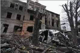 ?? EFREM LUKATSKY — ASSOCIATED PRESS ?? A building and car are destroyed by Russian shelling in Kharkiv, Ukraine. Russia's invasion of Ukraine likely will lead to the disruption of stability in global trade access.