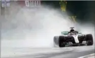  ?? LASZLO BALOGH — THE ASSOCIATED PRESS ?? Mercedes driver Lewis Hamilton of Britain steers his car during the qualifying session for the Hungarian Formula One Grand Prix, at the Hungarorin­g racetrack in Mogyorod, northeast of Budapest, Saturday. The Hungarian Grand Prix will be held on Sunday.