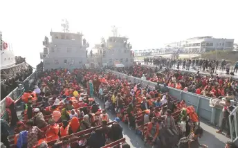  ?? — AFP photo ?? Rohingya refugees sit on a Bangladesh Navy ship as they are relocated to the controvers­ial flood-prone island Bhashan Char in the Bay of Bengal, in Chittagong.