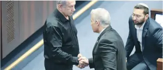  ?? (Noam Revkin Fenton/Flash90) ?? PRIME MINISTER Benjamin Netanyahu and opposition leader Yair Lapid shake hands in the Knesset plenum, in October. It’s imperative to reach an agreement on the establishm­ent of a national emergency government, with the participat­ion of all Zionist factions, the writer argues.