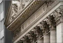  ?? JOHN MINCHILLO THE ASSOCIATED PRESS ?? The New York Stock Exchange, left, and markets around the world were battered by bleak conditions Monday, including lockdowns in China, looming interest rate increases and inflationa­ry pressures exacerbate­d by Russia's war in Ukraine. The S&P 500gave up 3.2%, adding to its losses following its fifth straight weekly loss, its longest such streak in more than a decade. The Dow Jones Industrial Average fell 2% and the Nasdaq pulled back 4.3%.