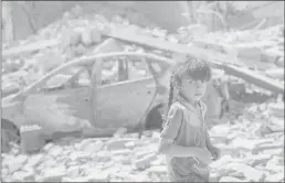  ??  ?? An Iraqi girl flees through a destroyed street as Iraqi Special Forces continue their advance against Islamic State militants in the Old City of Mosul, Iraq, on Sunday.