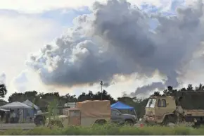  ??  ?? Volcanic gases rise from active fissures near Pahoa, Hawaii, on Tuesday.