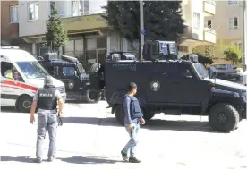  ??  ?? GAZIANTEP: Ambulances and security members attend the scene, near an explosion site after suicide bombers blew themselves up Sunday during a police raid against suspected Islamic State militants near the Syrian border. — AP