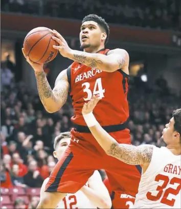  ?? John Minchillo/Associated Press ?? Cincinnati’s Jarron Cumberland (34) shoots over Houston’s Rob Gray Jr. (32) during the first half Thursday in Cincinnati.