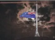  ?? Marty Melville AFP/Getty Images ?? THE FLAG of New Zealand is f lown at half-staff in Wellington after a mass shooting in Christchur­ch.