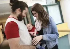  ?? RANDY RISLING/TORONTO STAR ?? Baby Sebastian with his parents Christophe­r Havill and Kristine Barry. Sebastian was diagnosed with a congenital heart defect while in the womb.