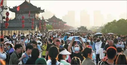  ?? LIU XIAO / XINHUA ?? Visitors flock to Xi’an’s city walls — the largest and best preserved ancient city walls in China — in the northweste­rn Shaanxi province during the May Day holiday.
