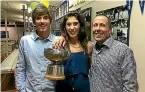  ??  ?? The Craig family celebrate after Megan won her second New Zealand squash title in Auckland on Sunday. From left, Chas Craig, Megan Craig and their father, Grant.