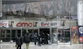  ??  ?? People enter an AMC theater Saturday in Los Angeles.