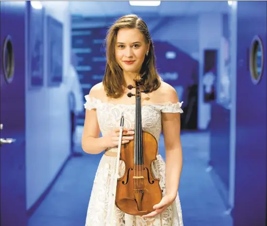  ?? Myung J. Chun Los Angeles Times ?? LAURA KUKKONEN, winner of the L.A. Philharmon­ic’s Play With Ray, performed Bach’s Concerto for Two Violins with star Ray Chen at the Hollywood Bowl.