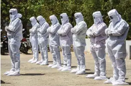  ?? — PTI ?? Health workers and volunteers wearing personal protective equipments (PPE) pray before carrying the body of a Covid-19 victim for burial in Chennai on Tuesday.