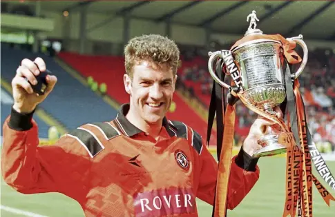  ?? ?? Craig Brewster, who went on to play for and manage Inverness, with the Scottish Cup he won with Dundee United in 1994 as he scored the winner in the 1-0 Hampden triumph against Rangers. Image: SNS.
