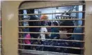  ??  ?? Children aboard a train leave for industrial cities for work. Photograph: Manoj Chaurasia