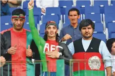  ?? Ahmed Kutty/Gulf News ?? Afghanista­n fans show their true colours during the match with Bangladesh in Abu Dhabi.