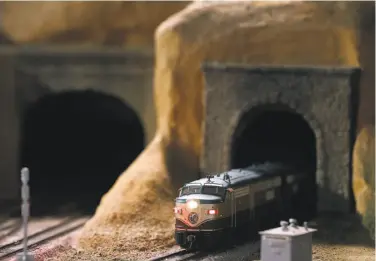  ??  ?? Above: Gary Valentinse­n (left) and Wayne Monger monitor HO scale trains running on the tracks in one of the club’s Quonset huts. Below: A little train rolls through a tunnel in the scaled Napa Valley landscape.