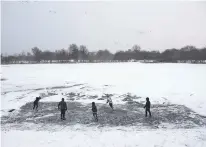  ?? ASSOCIATED PRESS FILE PHOTO ?? Youths play ice hockey on a frozen pond in January 2018 at Philadelph­ia’s Franklin Delano Roosevelt Park during a winter storm. New concussion guidance shows there isn’t enough solid evidence to answer some of parents’ most burning questions about contact sports. That includes what age is safest to start playing them.