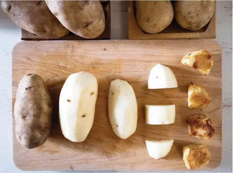  ?? PHOTOS: KaREN BARNABY ?? The ultimate roast potatoes — the elusive crusty and crispy side dish — from start, to skin off, to cut up, and finally roasted.