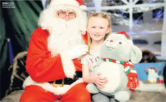  ??  ?? Smiles Kayla McDonald, 6, meeting Santa