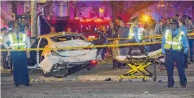  ?? THE ASSOCIATED PRESS ?? Police respond to a scene where a pickup truck plowed into a crowd watching the Krewe of Endymion parade and injured multiple people in the Mid-City section of New Orleans.