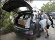  ?? CHUCK BURTON—THE ASSOCIATED PRESS ?? Jason Moore, of Raleigh, N.C., packs to evacuate from Wrightsvil­le Beach, N.C., Wednesday as Hurricane Florence threatens the coast.