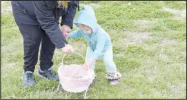  ?? ?? A child gets help with her Easter basket.