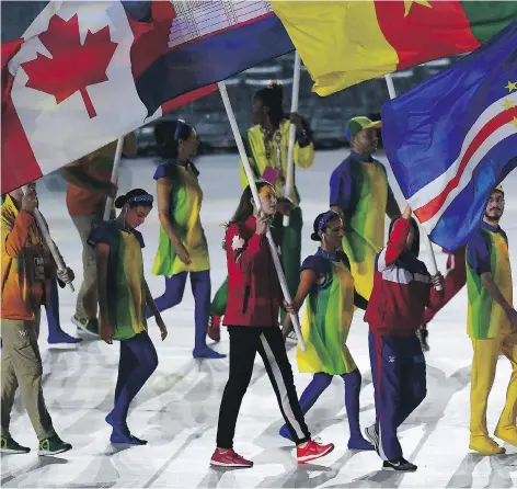  ?? PASCAL LE SEGRETAIN/GETTY IMAGES ?? Canada’s Penny Oleksiak, centre, and other flag-bearers enter Maracana stadium during the closing ceremony of the Olympic Games on Sunday in Rio. The 16-year-old Toronto swimmer was chosen after winning four medals, including a gold, in Rio.