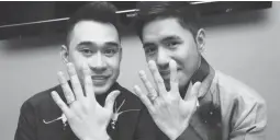  ??  ?? SAME-SEX MARRIAGE – Filipino couple Jonathan Sac (left) and Kristoffer Flaminiano (right), in a photo posted on Facebook, show off their wedding rings. The couple has been married since January 2013 in Edmonton, Canada. The fate of same-sex couples,...