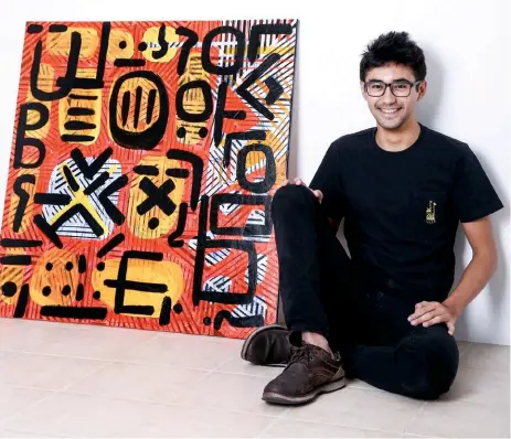  ??  ?? coming of age Enzo Razon (shown with an unframed abstract on canvas); Razon’s abstract pieces speak of his unique point of view