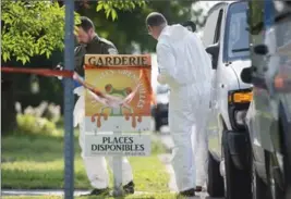  ?? GRAHAM HUGHES, THE CANADIAN PRESS ?? Police forensic investigat­ors at a home in Saint-Eustache, Que., Friday. The mother of a 6-year-old boy who was the subject of an Amber Alert was found dead in the house.