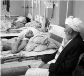  ?? PHOTO: AP/PTI ?? Afghans lie on beds at a hospital after they were wounded in the terror attack outside the airport in Kabul. According to one estimate, the incident has claimed 169 Afghans, so far